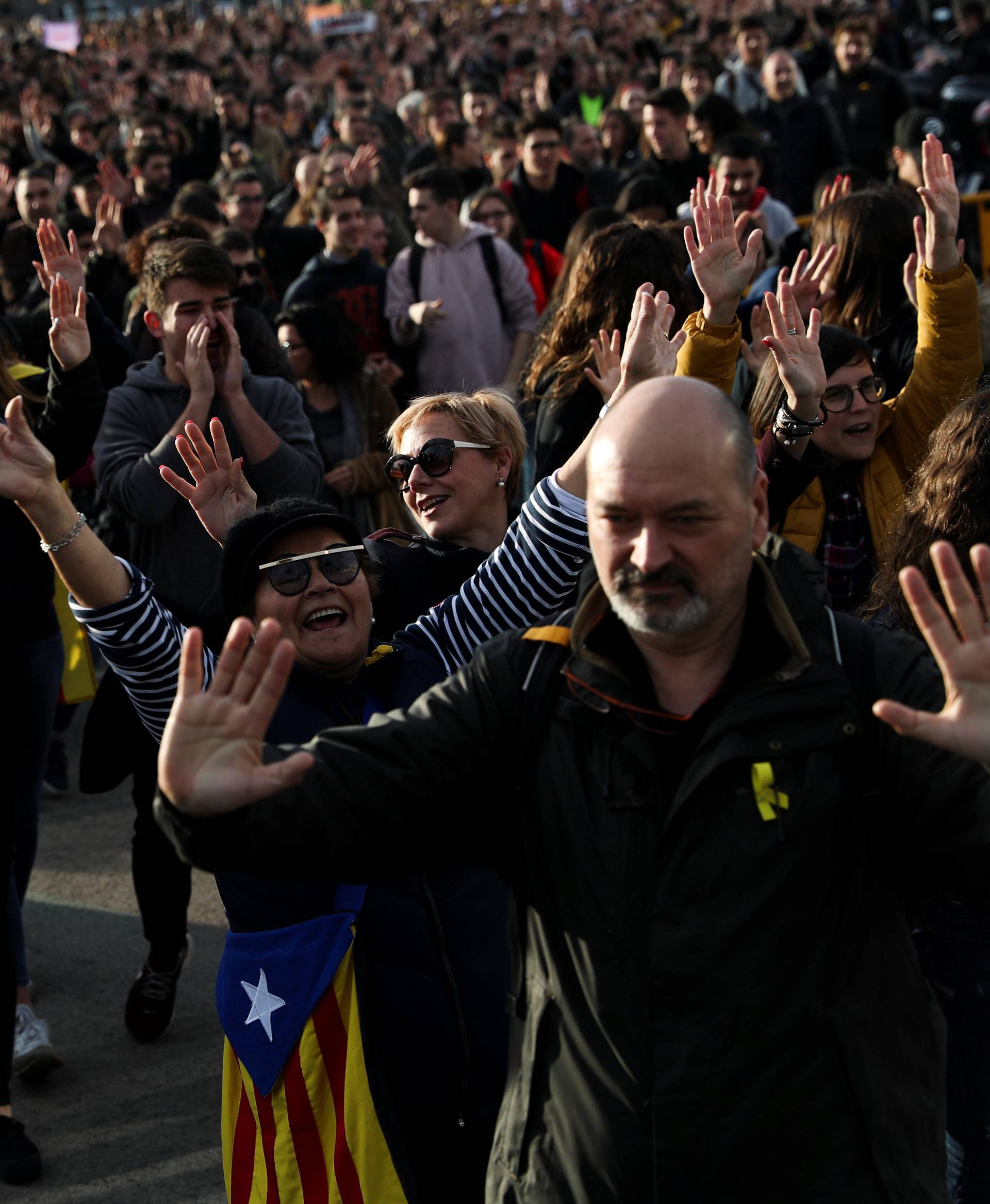 People take part in a protest against the imprisonment of Catalan separatist leaders outside Sants train station in Barcelona