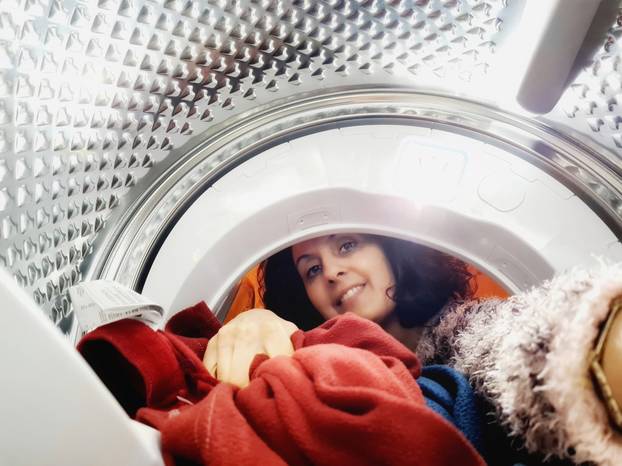 Italian housewife photographed while removing clothes from the dryer