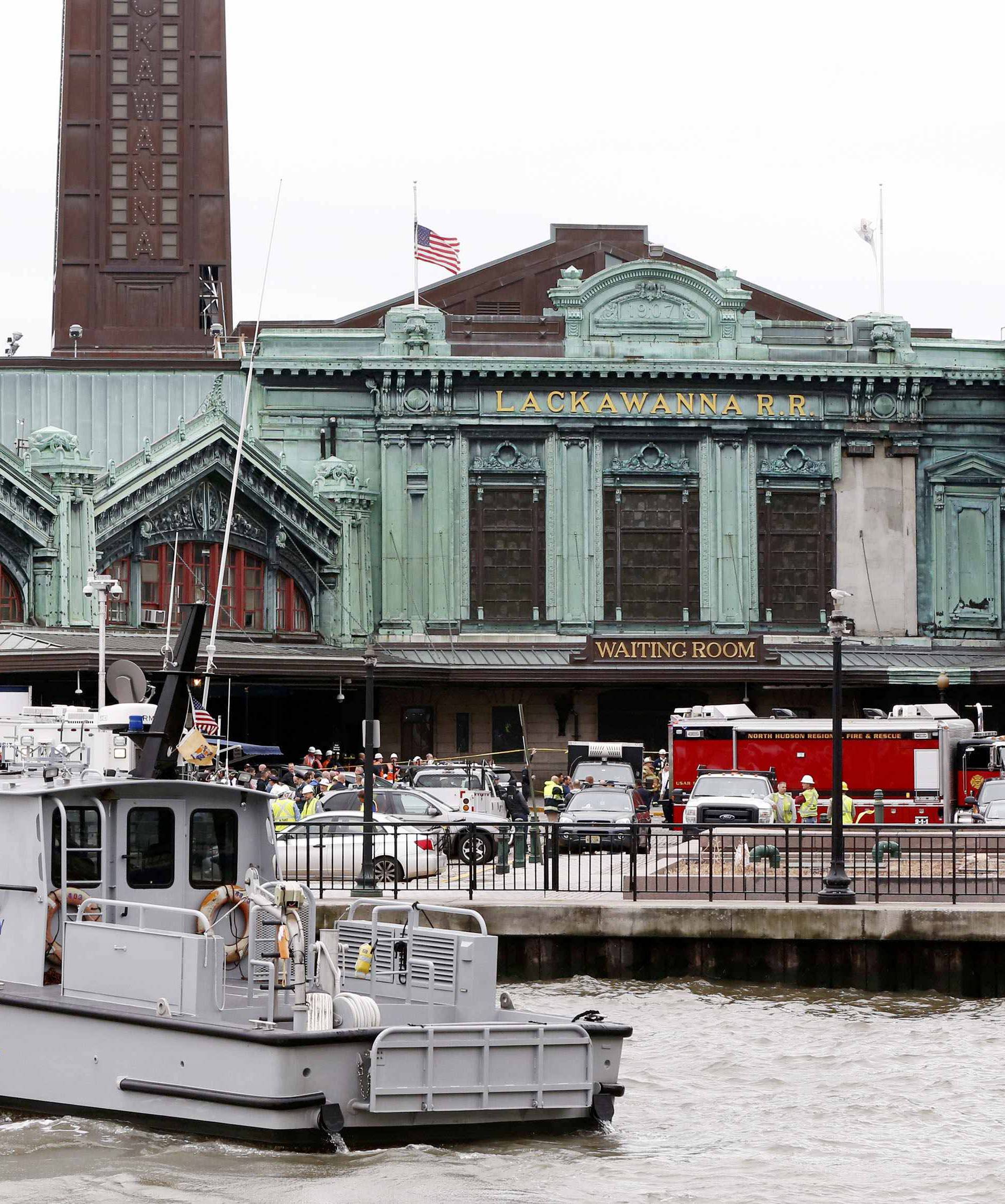 Rescue crews and police gather at the Hoboken train station, where a New Jersey Transit train derailed and crashed through the station, injuring more than 100 people, in Hoboken