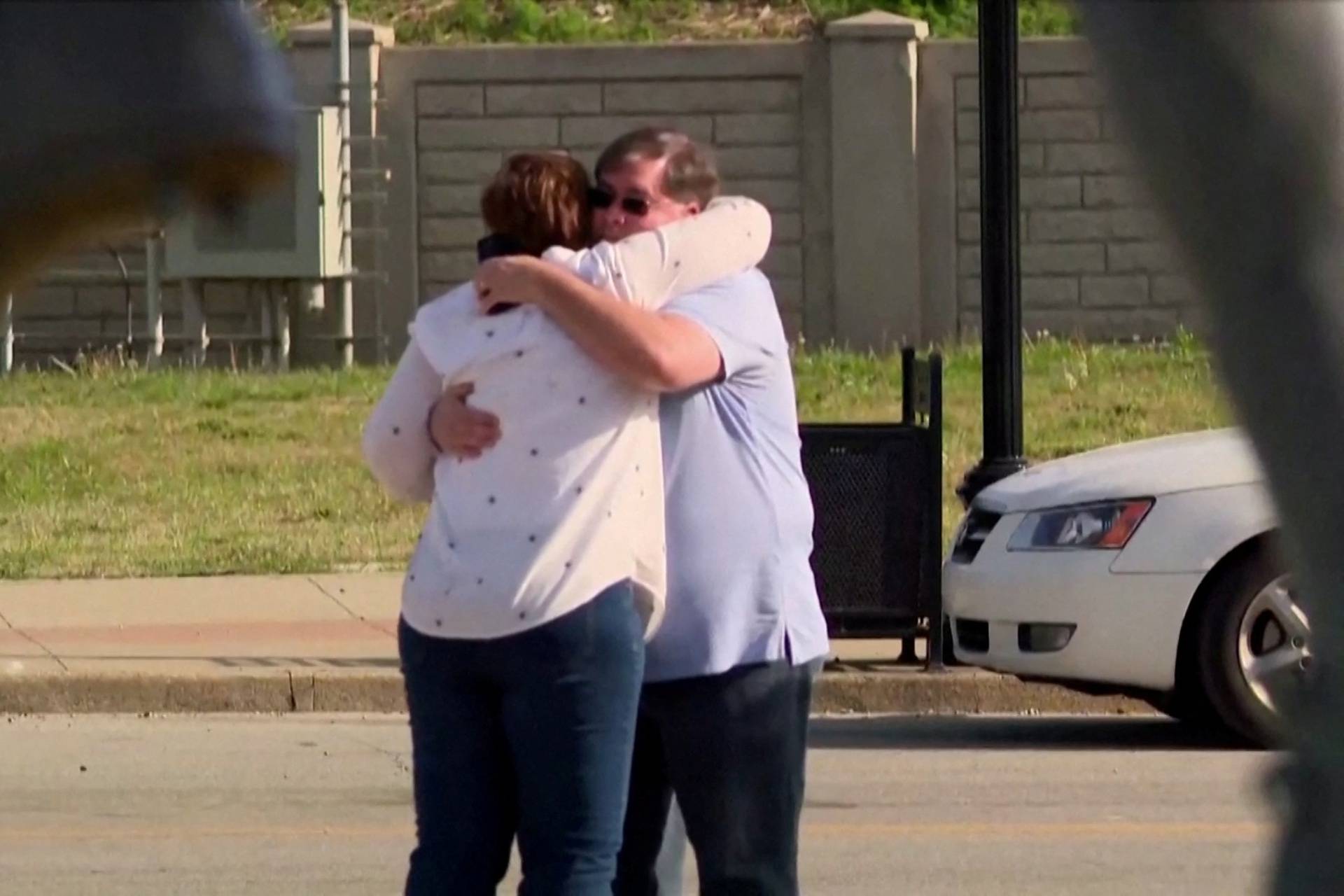 People embrace after an "active police situation" in Louisville