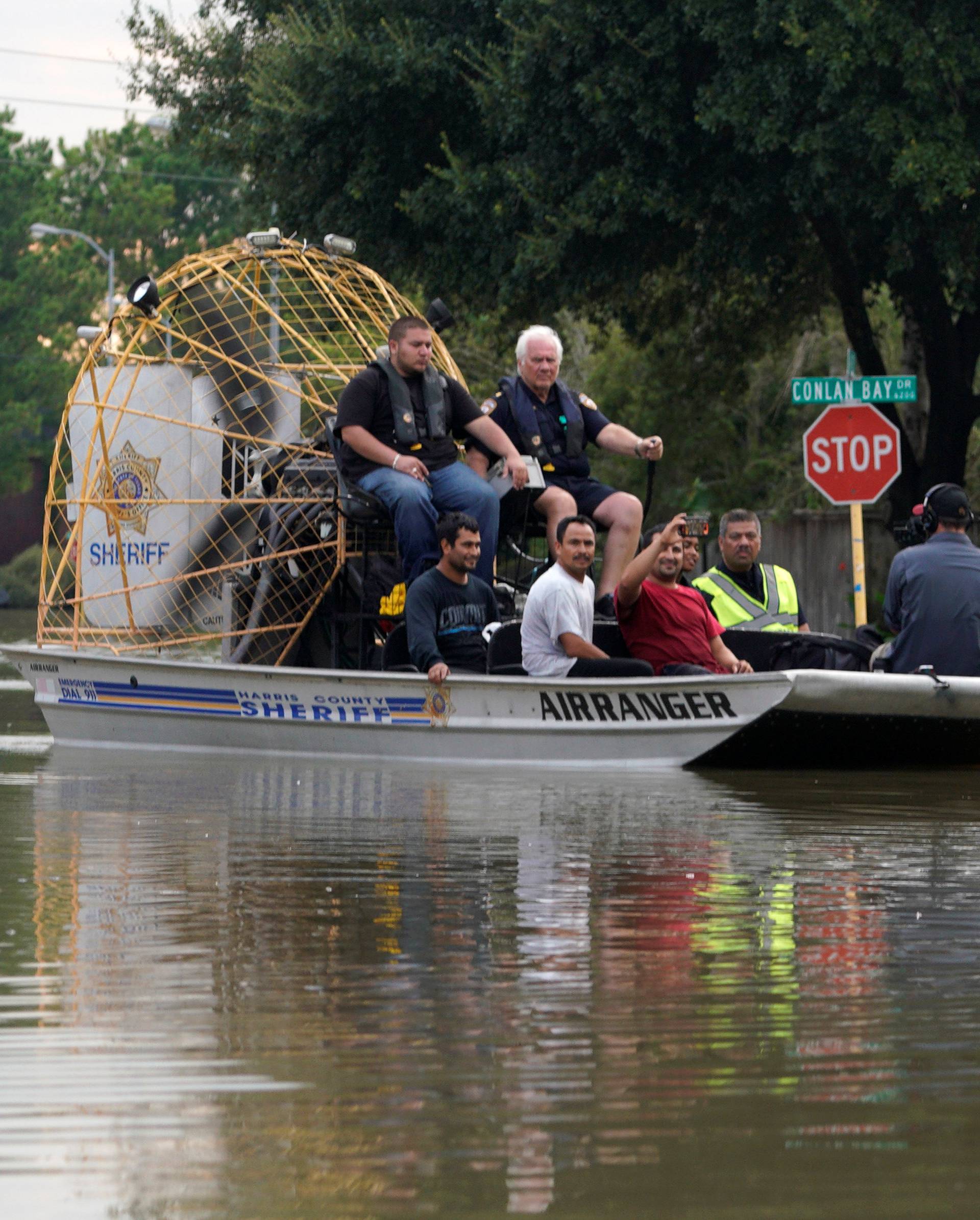 People are evacuated by airboat from the Tropical Storm Harvey floodwaters in north western Houston
