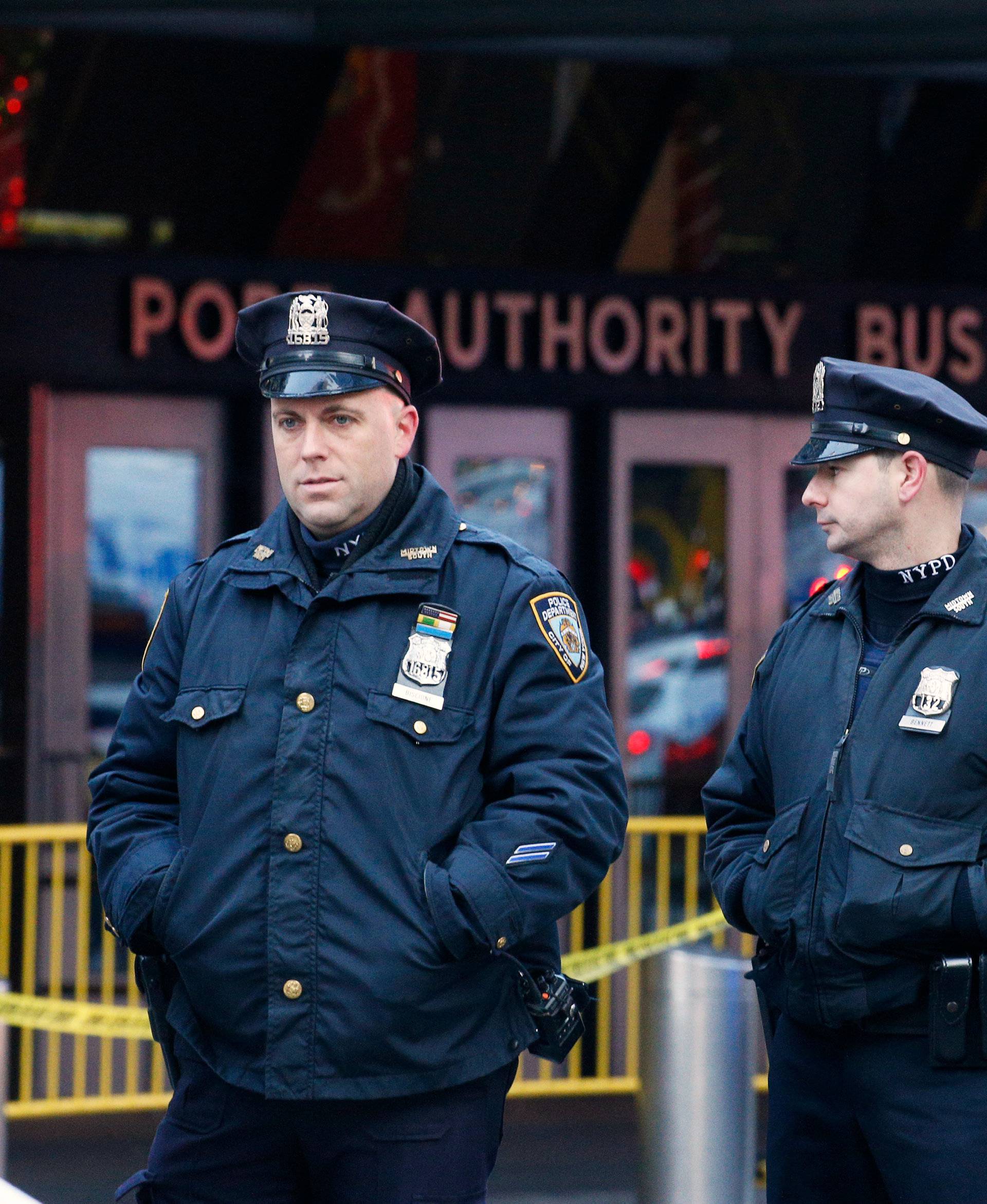 Police officers stand outside the New York Port Authority Bus Terminal in New York City after reports of an explosion