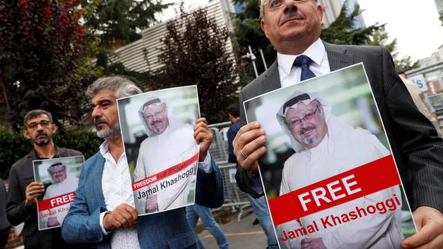 Human rights activists and friends of Saudi journalist Khashoggi hold his pictures during a protest outside the Saudi Consulate in Istanbul