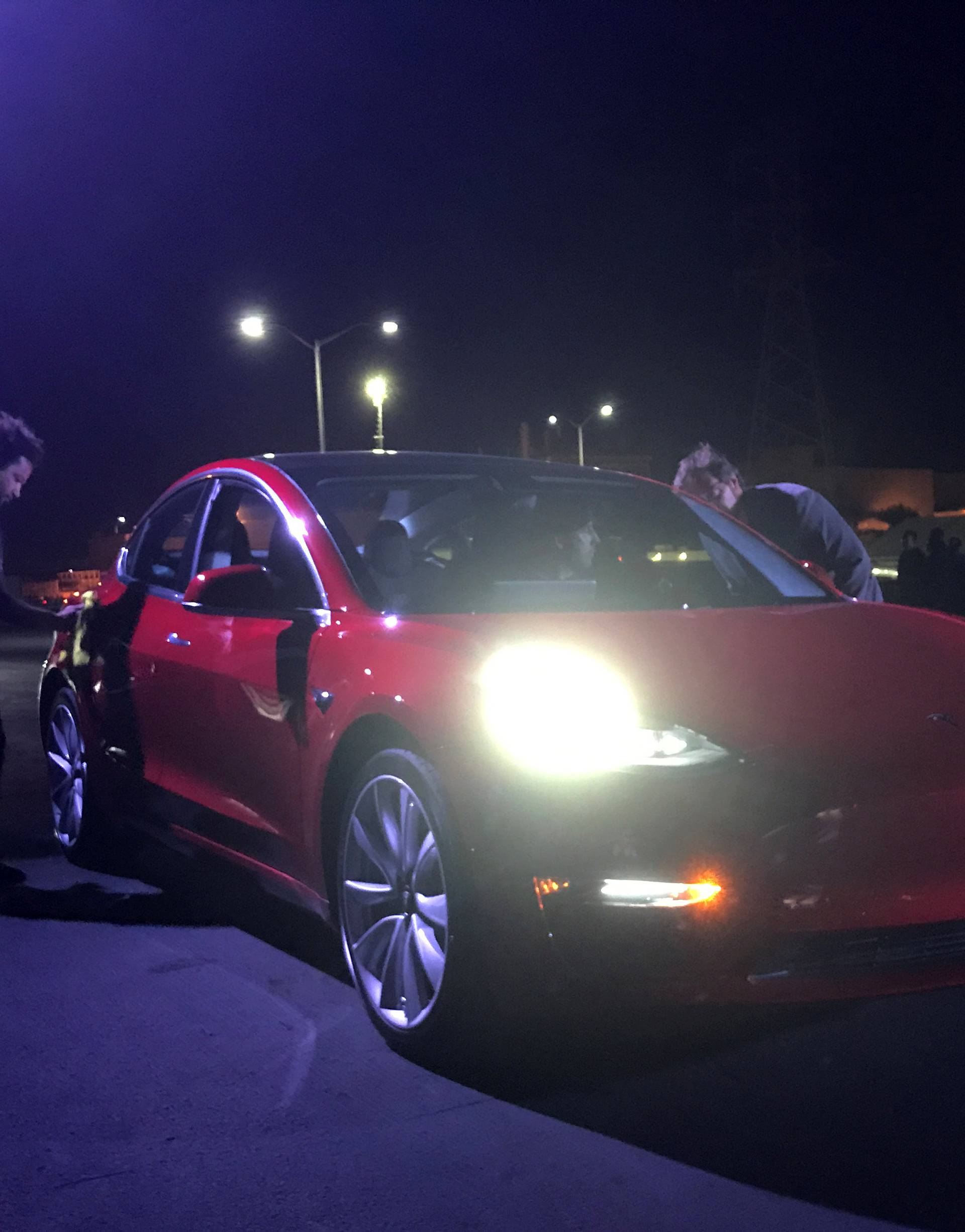 Customer employees receive some of the first Model 3 cars off the Fremont factory's production line during an event at the company's facilities in Fremont, California