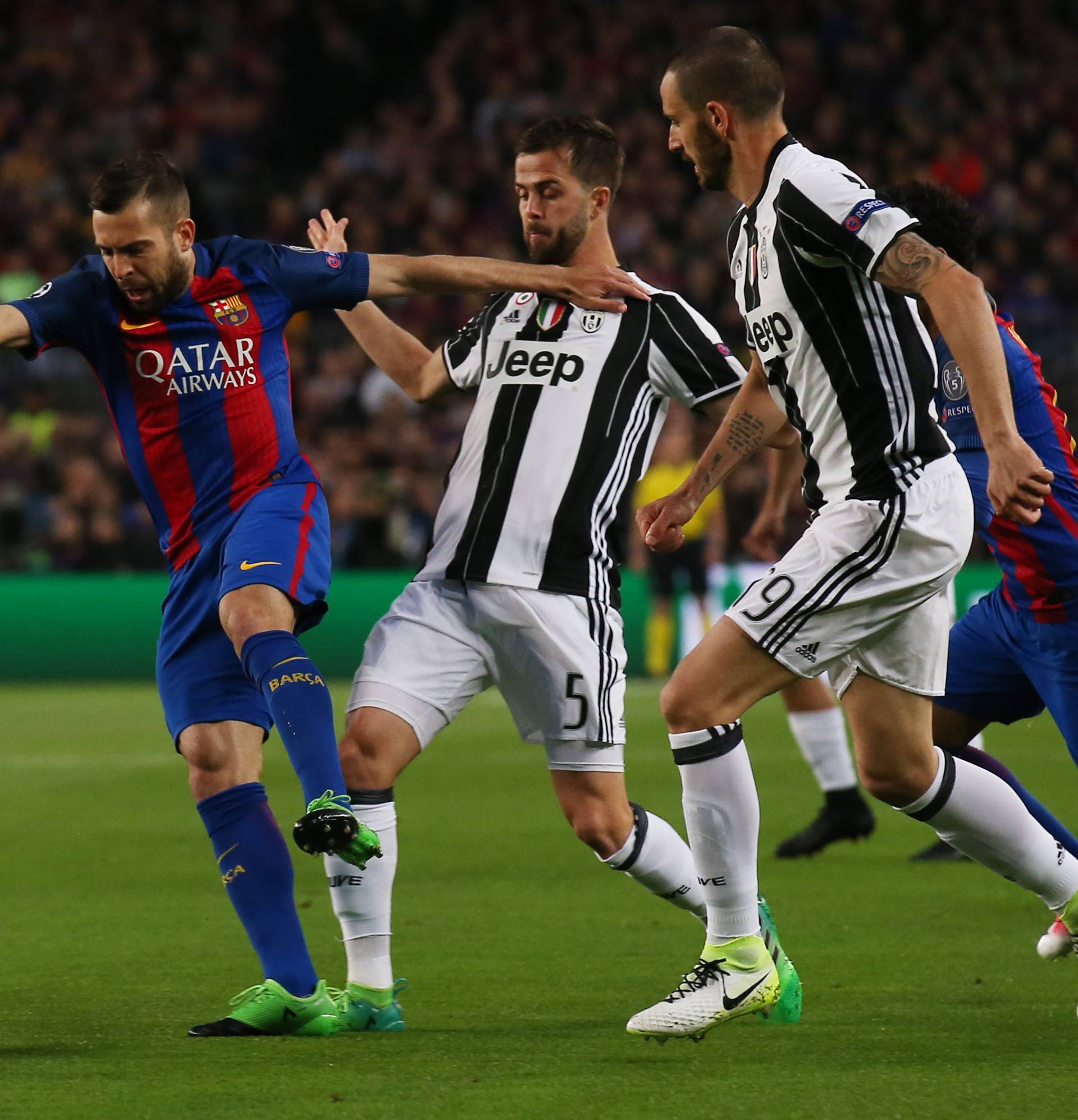 Barcelona's Jordi Alba in action with Juventus' Miralem Pjanic and Leonardo Bonucci