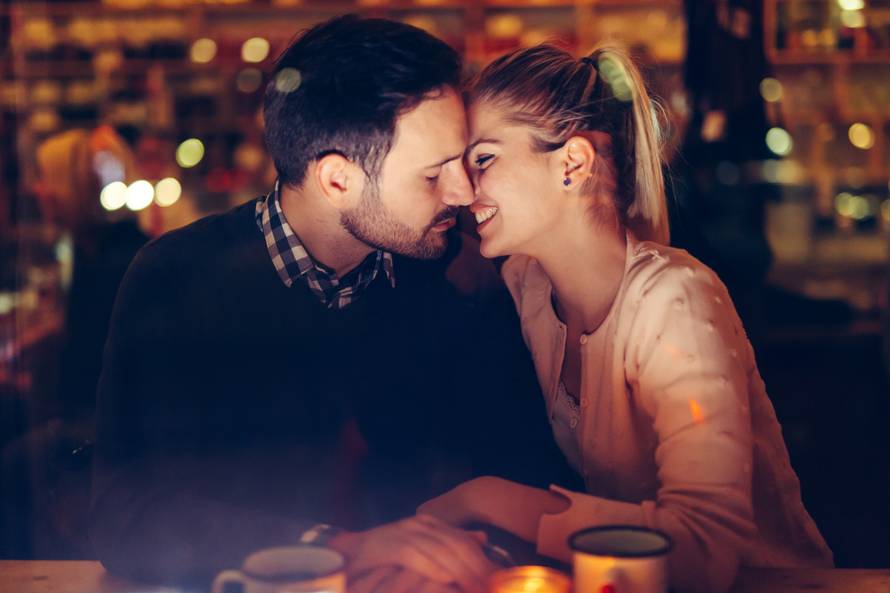 Romantic couple dating in pub at night