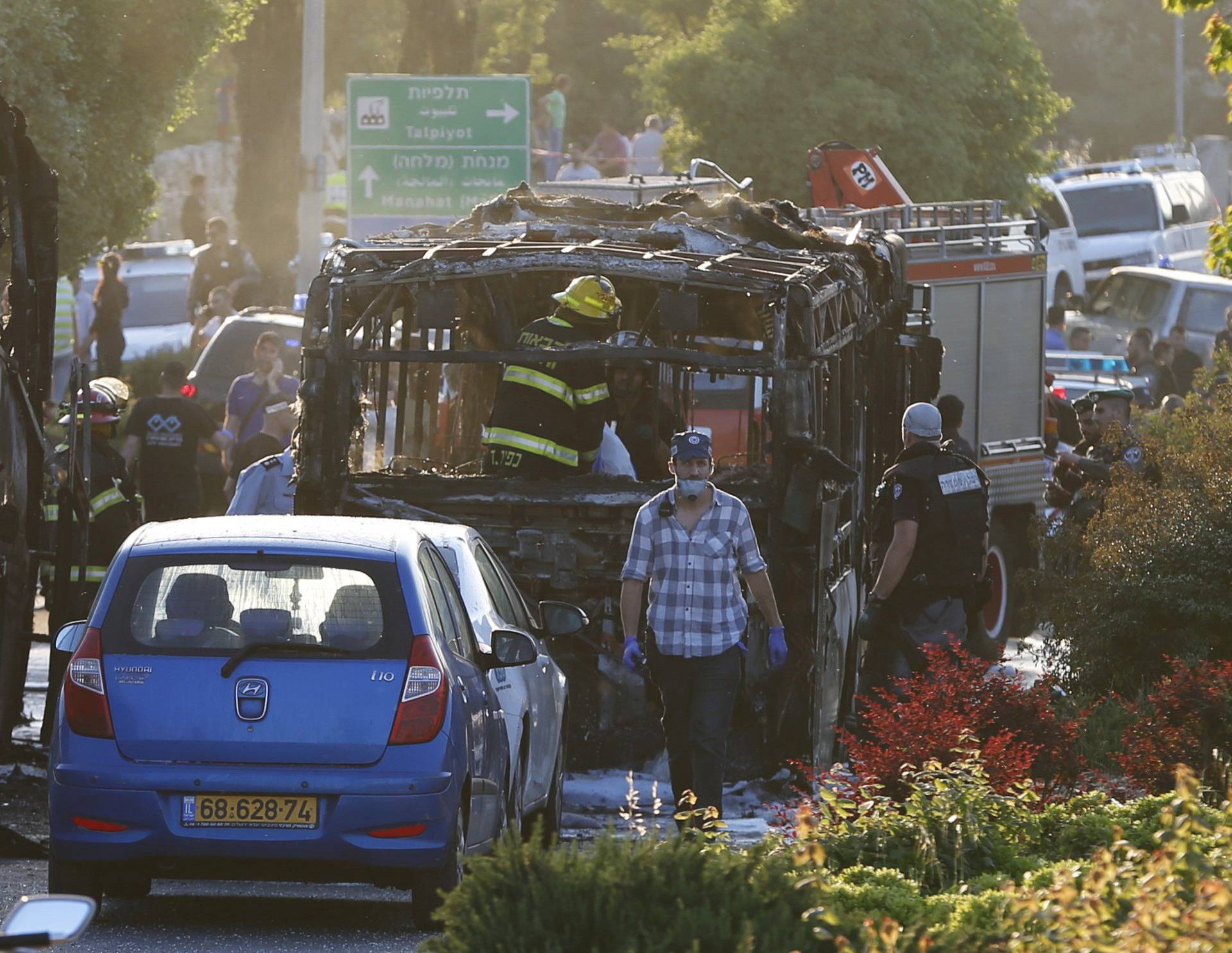 Emergency workers search the scene after a blast on a bus in Jerusalem