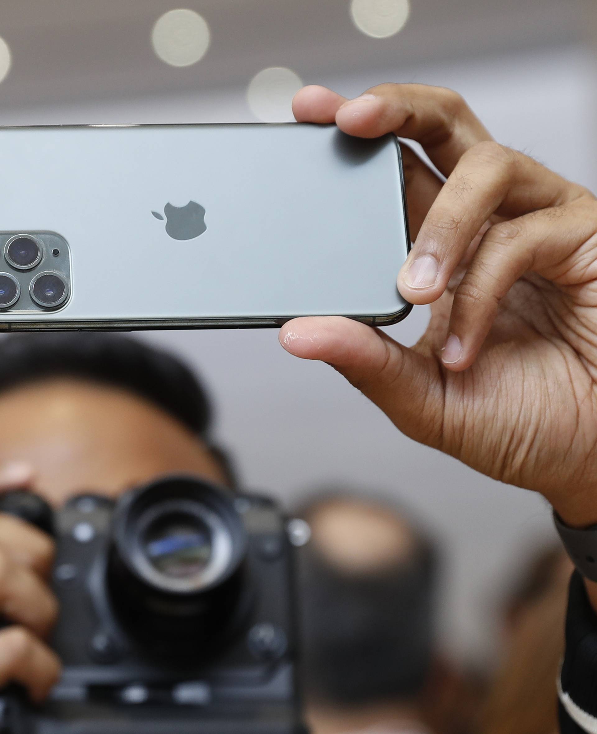 People take photos of the new iPhone  11 Pro in the demonstration room at an Apple event at their headquarters in Cupertino