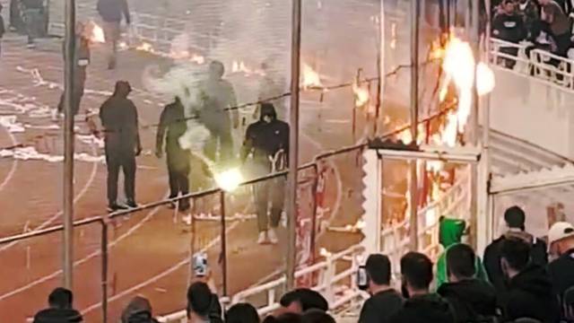 Panathinaikos fans burn flags during their Super League match at the OAKA Spiros Louis stadium in Athens