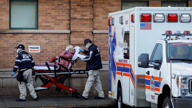 Paramedics take a patient in to an emergency center at Maimonides Medical Center during the outbreak of the coronavirus disease (COVID-19) in the Brooklyn, New York