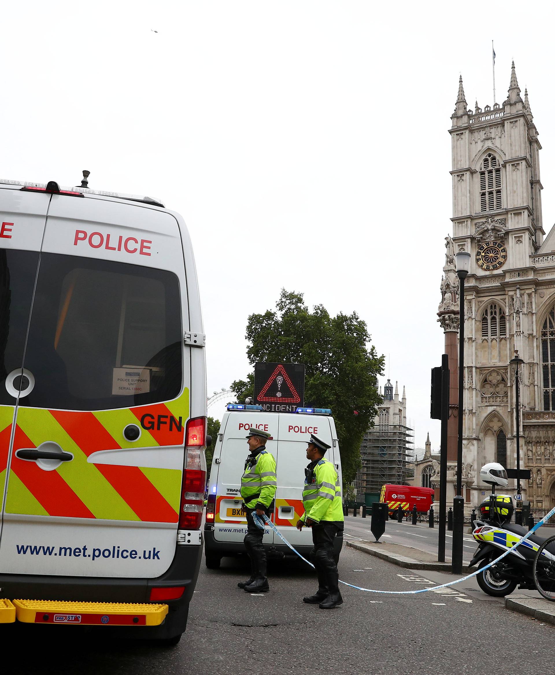 Police officers stand at a cordon after a car crashed outside the Houses of Parliament in Westminster, London