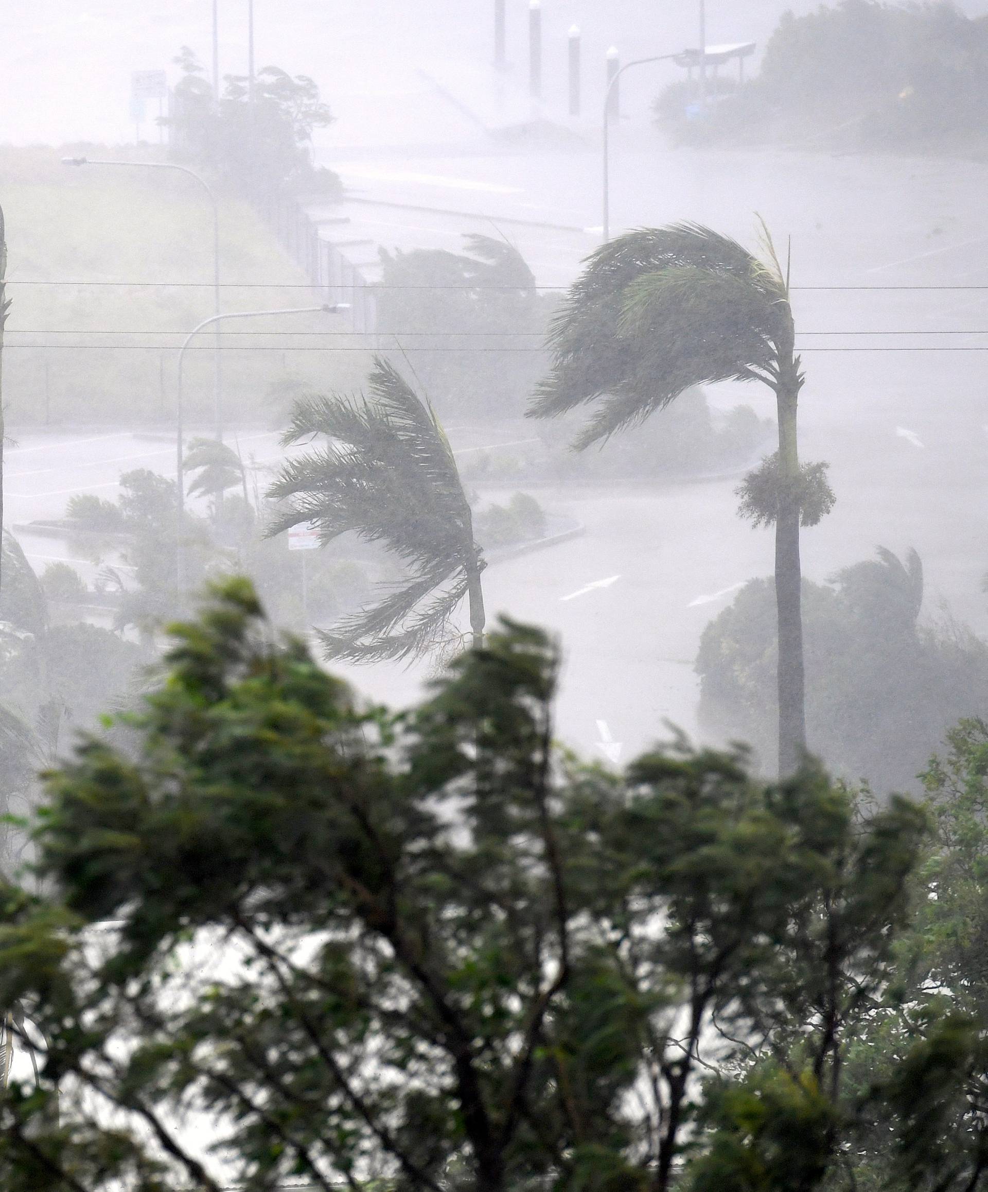 Strong wind and rain from Cyclone Debbie is seen effecting trees at Airlie Beach, located south of the northern Australian city of Townsville