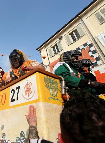 Members of rival teams fight with oranges during an annual carnival battle in the northern Italian town of Ivrea