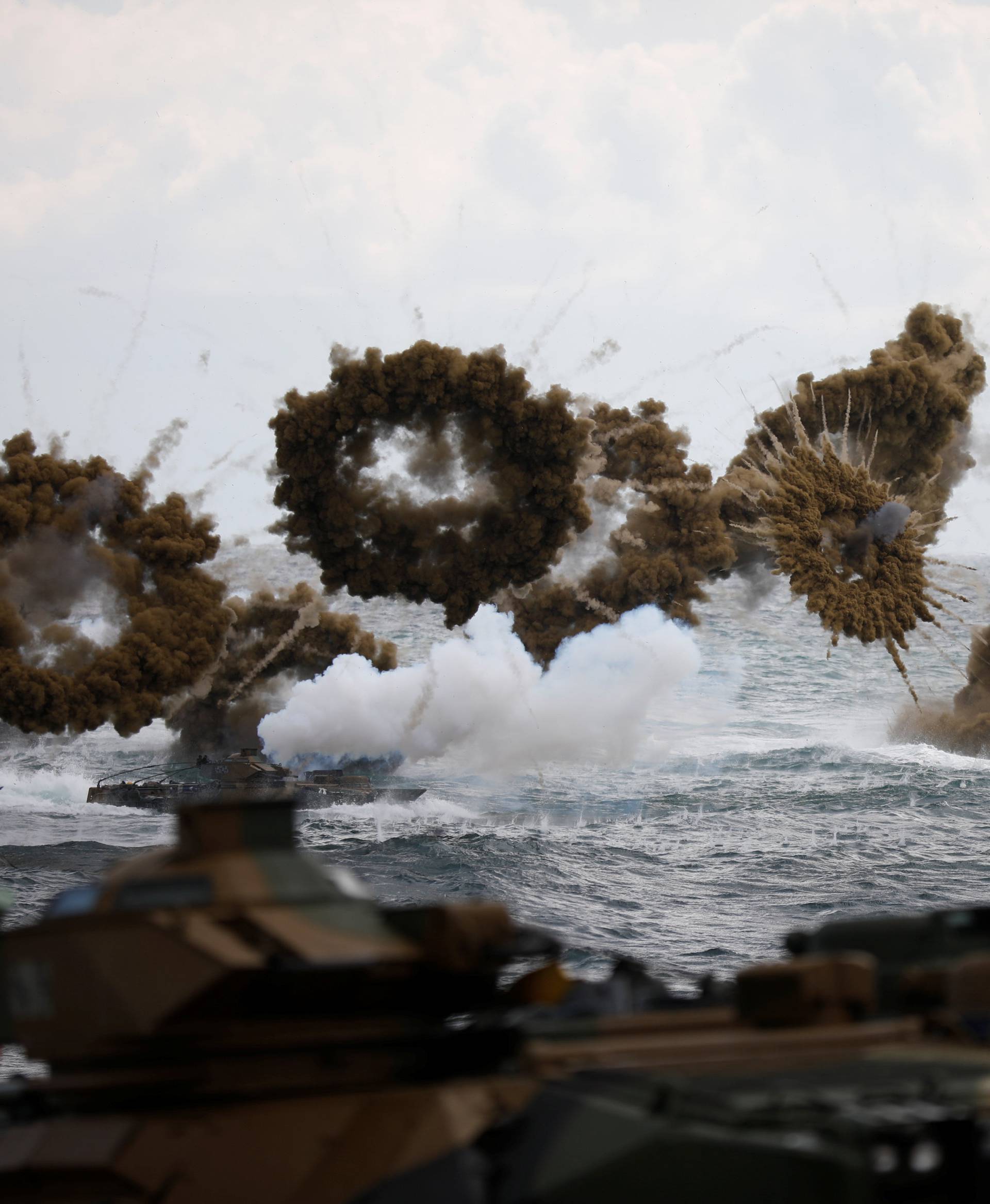 Amphibious assault vehicles of the South Korean Marine Corps fire smoke bombs as they move to land on the shore during a U.S.-South Korea joint landing operation drill as a part of the two countries' annual military training called Foal Eagle, in Pohang