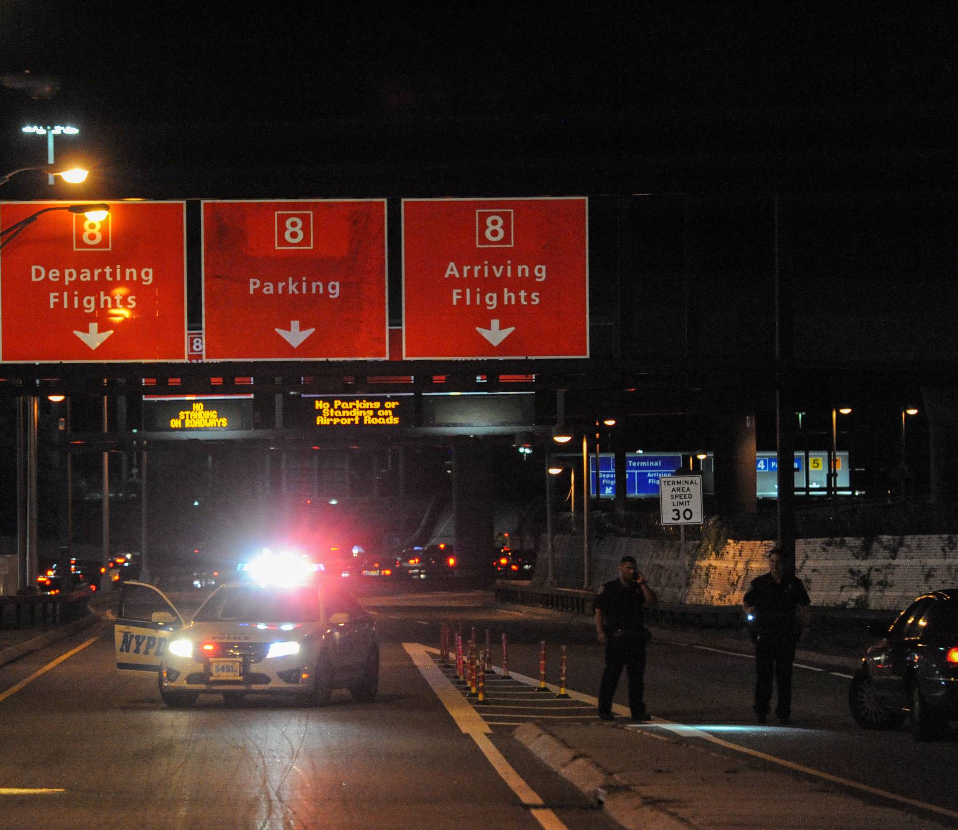 Members of the New York City Police Department block vehicle access to Terminal 8 at John F. Kennedy airport in the Queens borough of New York City