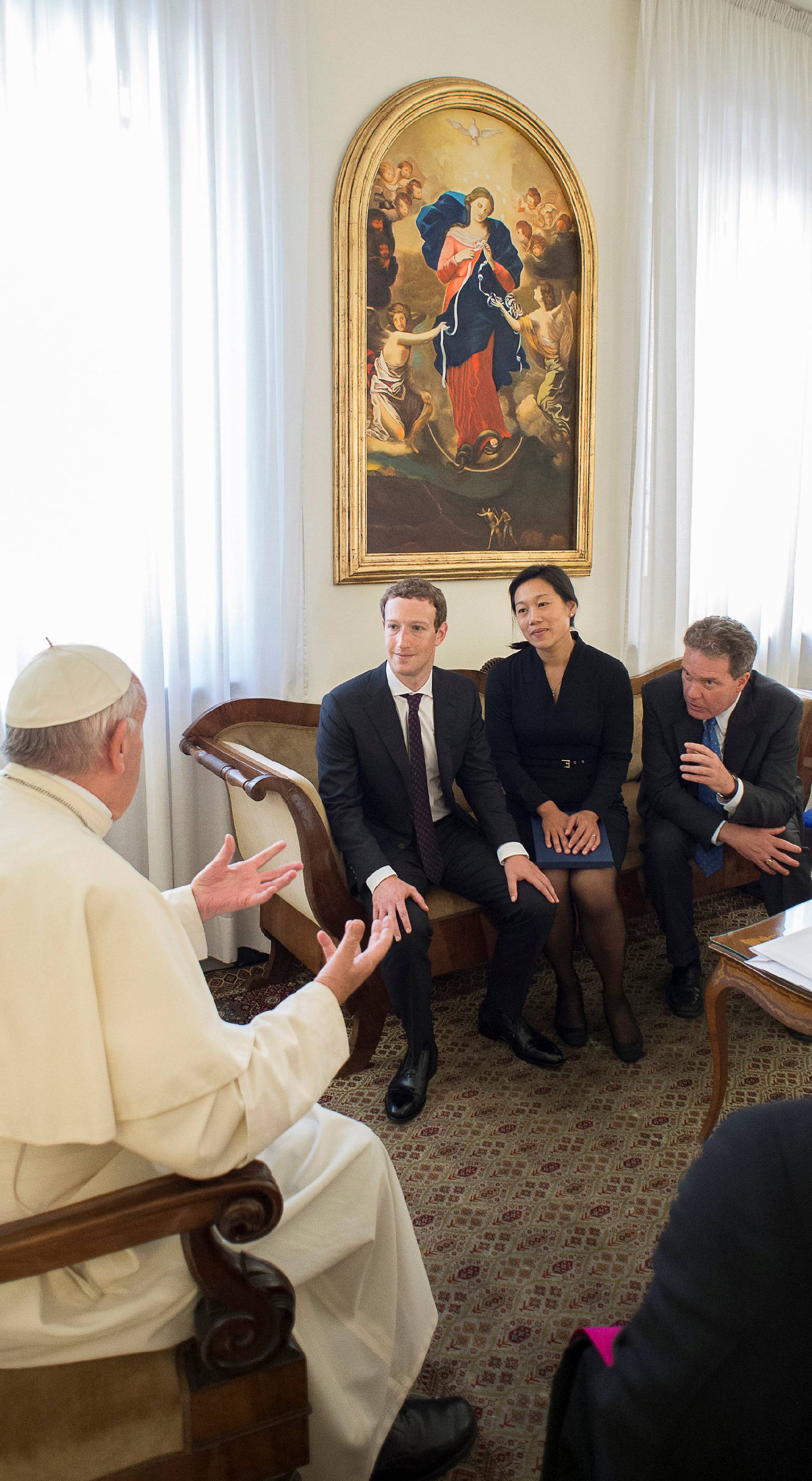 Pope Francis talks to Facebook CEO Zuckerberg and his wife Chan during a meeting at the Vatican 