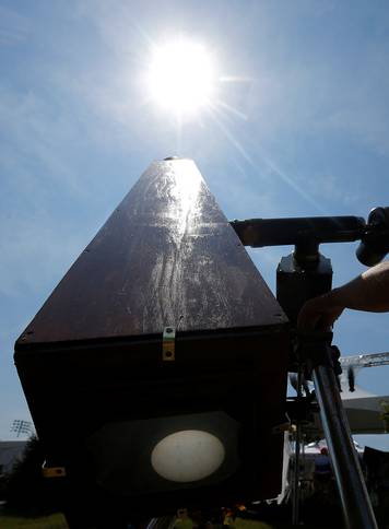 Photographer C.D. Olsen adjusts his replica of the Kew Photo Heliograph outside the football stadium at Southern Illinois University in Carbondale