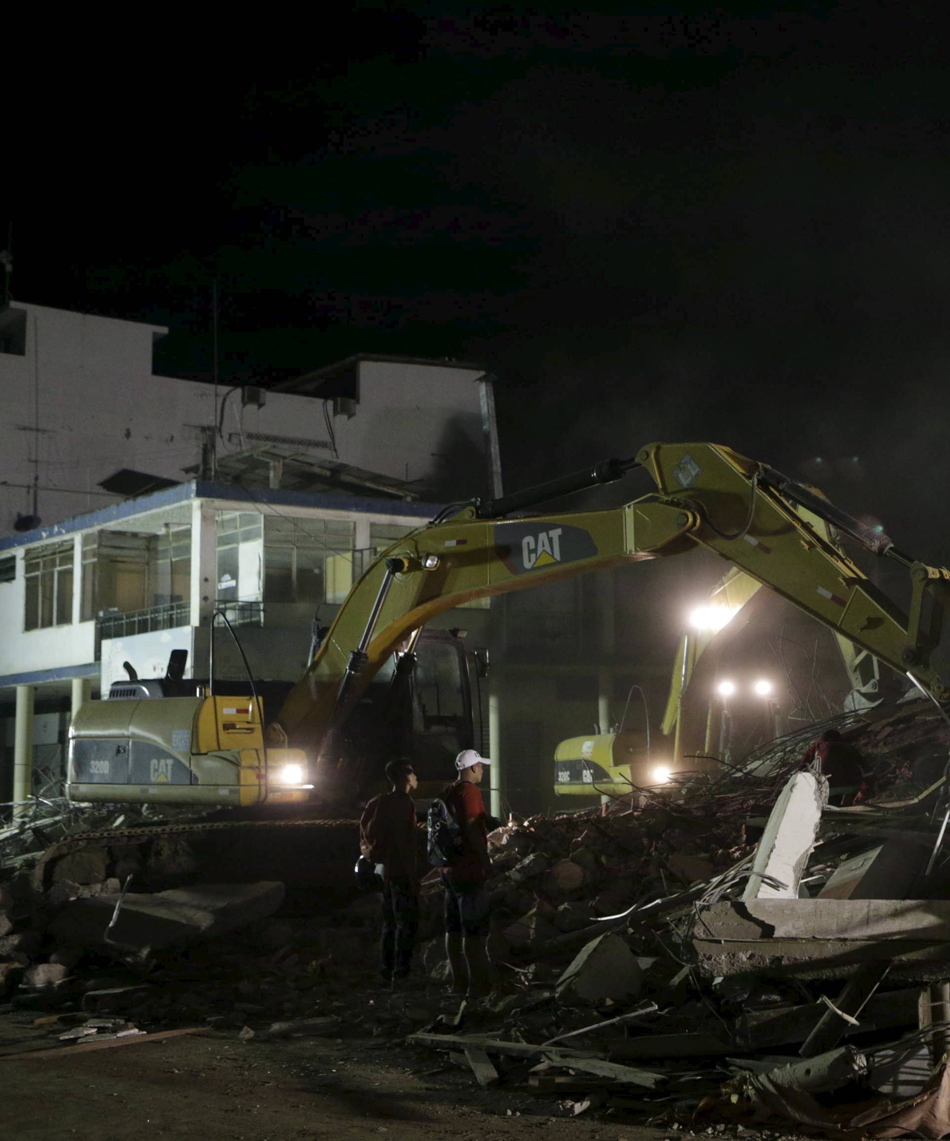 Mechanical shovel remove debris of a collapsed hotel after an earthquake struck off the Pacific coast, in Portoviejo, Ecuador