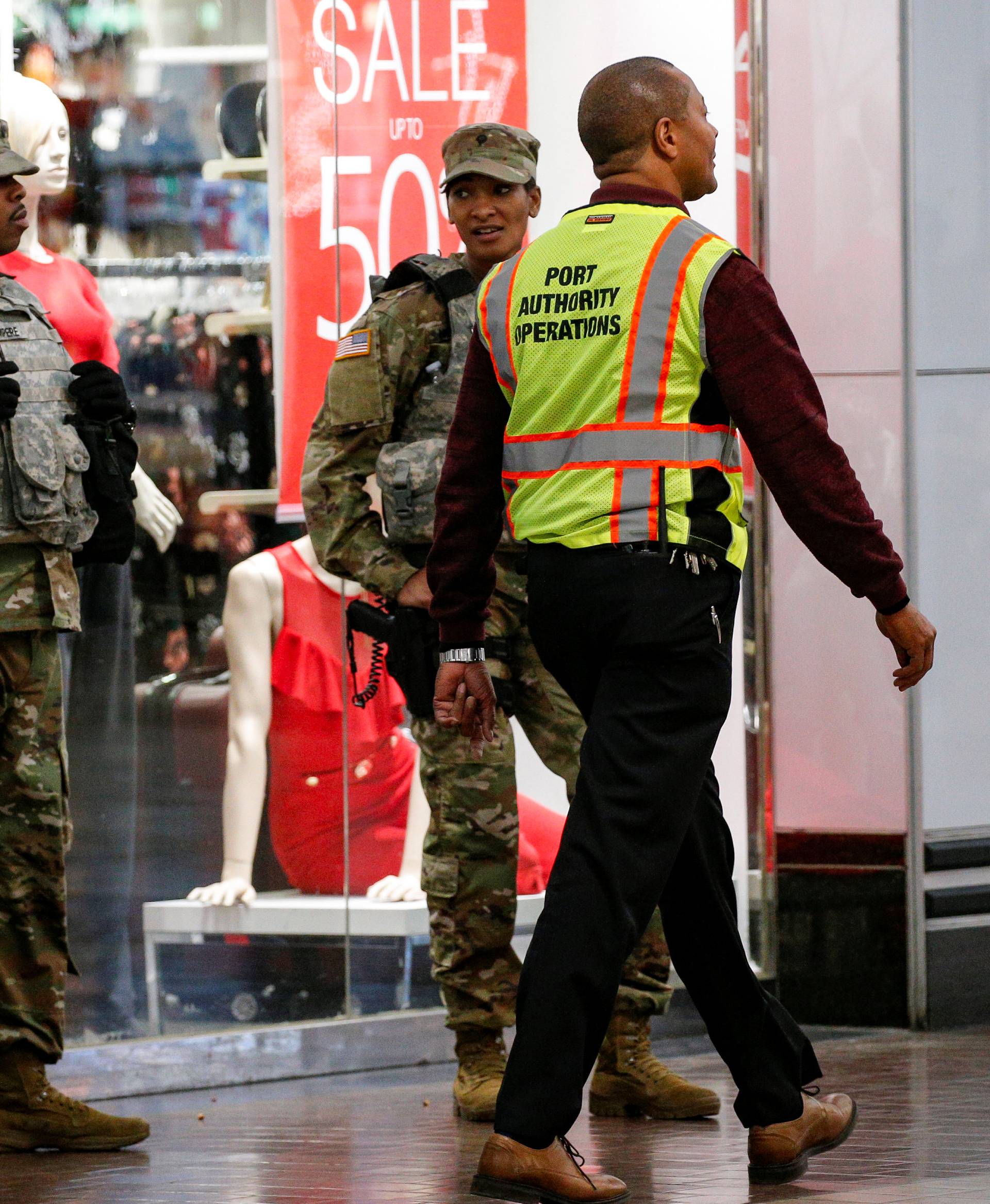 Security personnel patrol inside the New York Port Authority bus terminal following an attempted detonation during the morning rush hour in New York