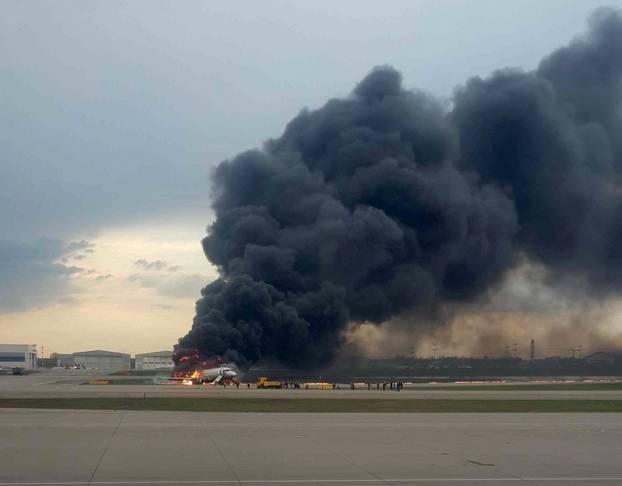 A passenger plane is seen on fire after an emergency landing at the Sheremetyevo Airport outside Moscow