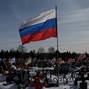 Flags fly over the graves of Russian soldiers at a cemetery in Moscow region