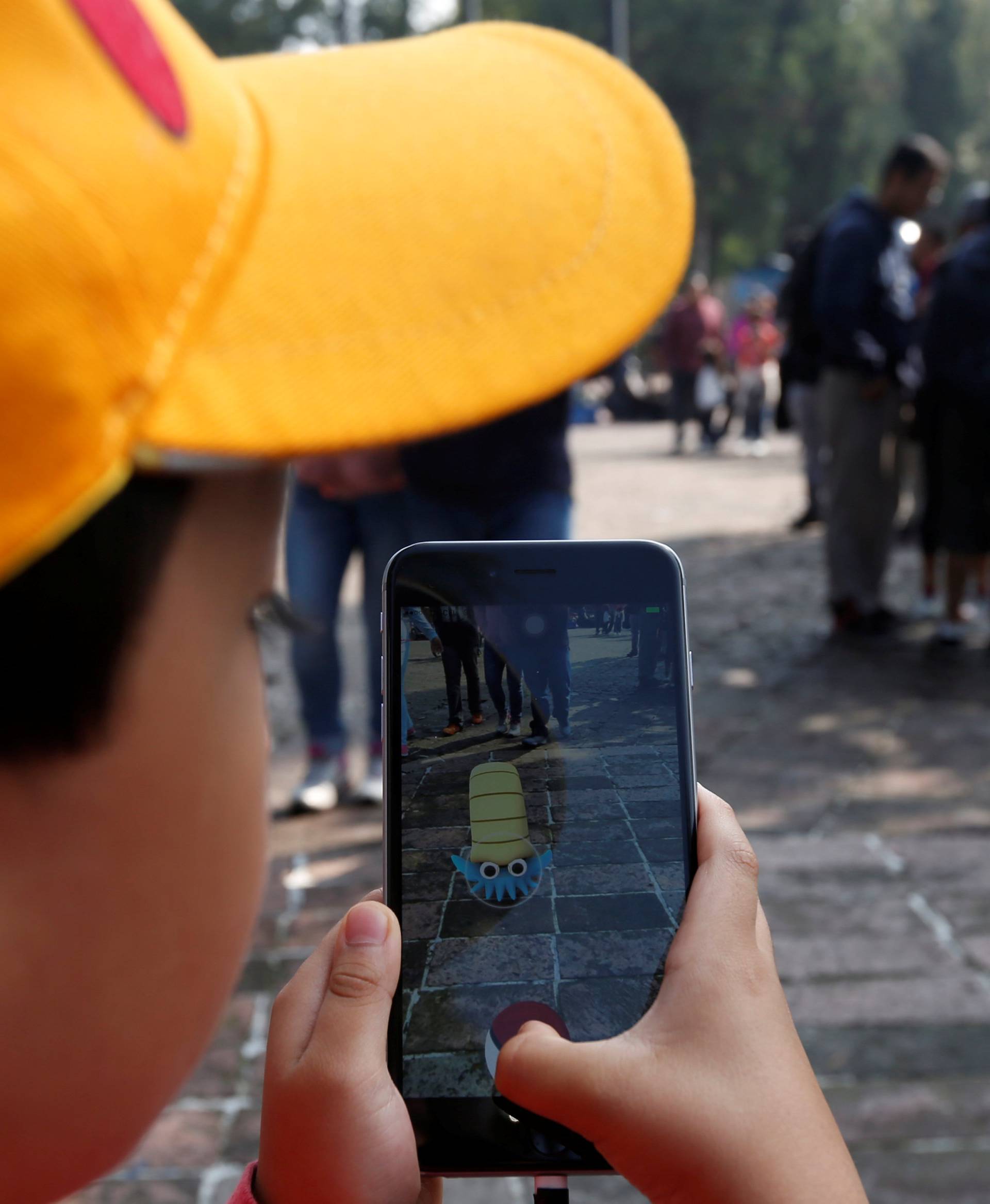 A child plays Pokemon Go during a gathering to celebrate "Pokemon Day" in Mexico City, Mexico 