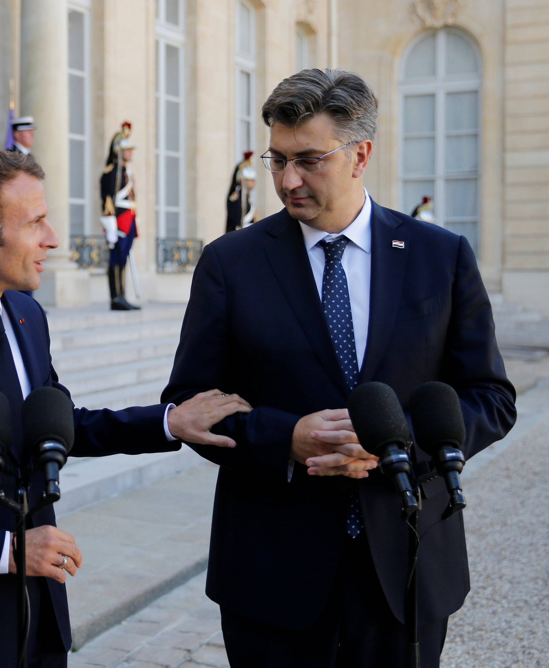 French President Emmanuel Macron and Croatian Prime Minister Andrej Plenkovic make a statement in the courtyard of the Elysee Palace in Paris
