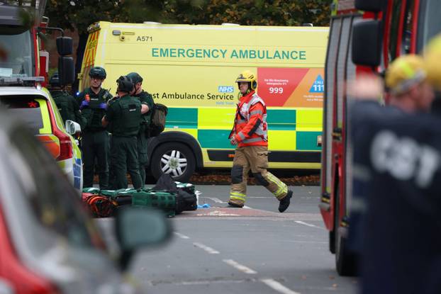 Police officers work at the scene following an incident outside a synagogue, in Manchester