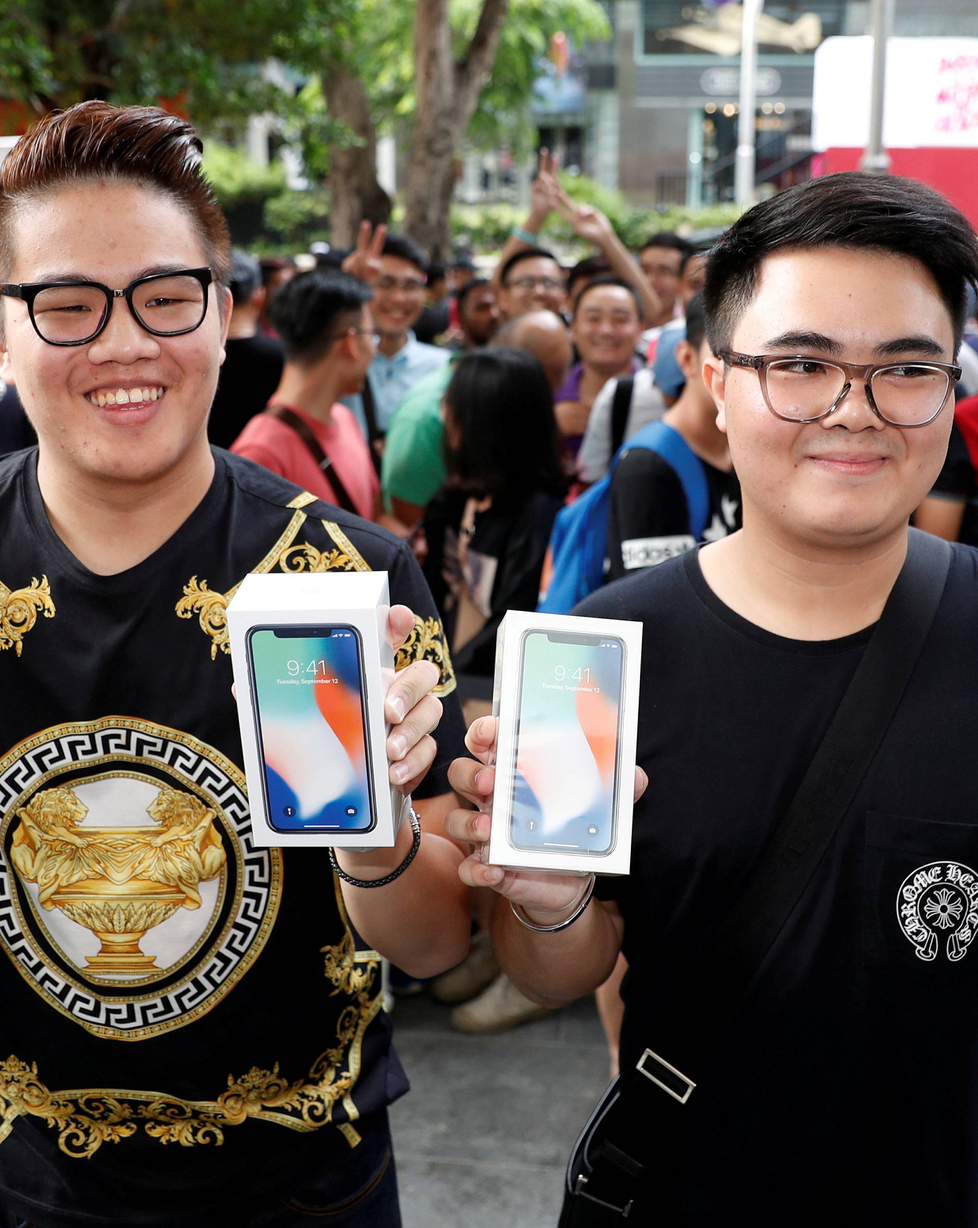 First customers to buy iPhone X Kittiwat Wang, 22, and Mod, 22, of Bangkok pose with their iPhone X at the Apple store in Singapore