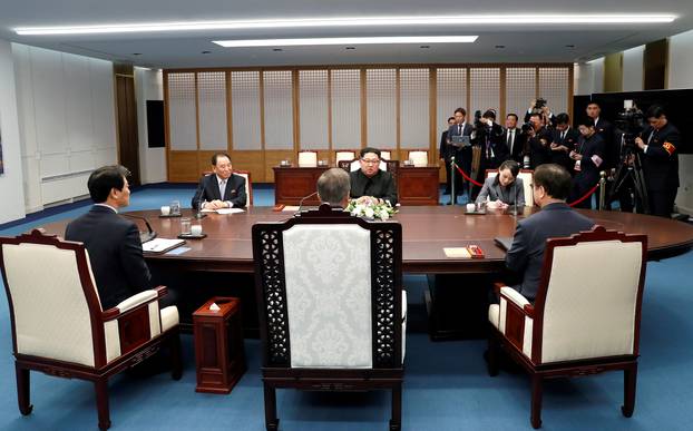 South Korean President Moon Jae-in talks with North Korean leader Kim Jong Un during their meeting at the Peace House