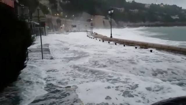 Waves flood the street in Villefranche-Sur-Mer