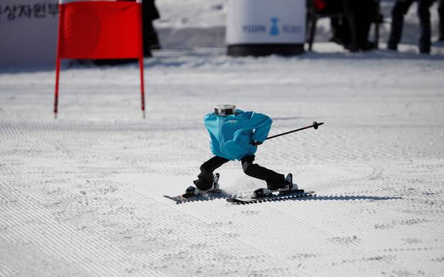 Robot Tae Kwon V skies during the Ski Robot Challenge at a ski resort in Hoenseong