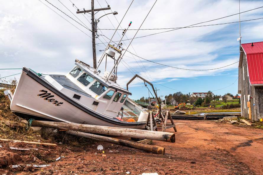 A lobster boat beached during Hurricane Fiona is seen at Stanley Bridge Marina