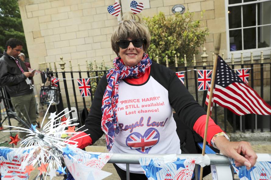 Donna Werner from the U.S., who is a super-fan of Britain's Royal Family, arranges flags and decorations near the spot she has chosen outside Windsor Castle from which to witness Prince Harry and Meghan Markle's carriage procession after their wedding, in