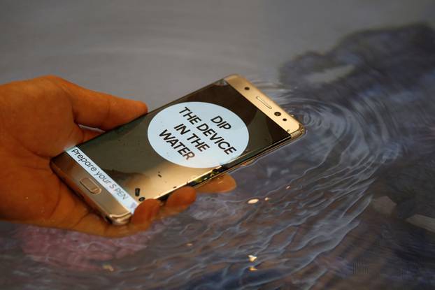 A model demonstrates waterproof function of Galaxy Note 7 new smartphone during its launching ceremony in Seoul