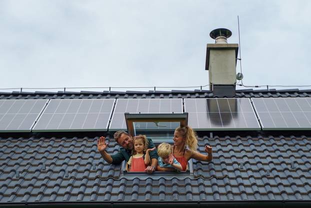 Happy,Family,Waving,From,Skylight,Window,In,Their,New,House