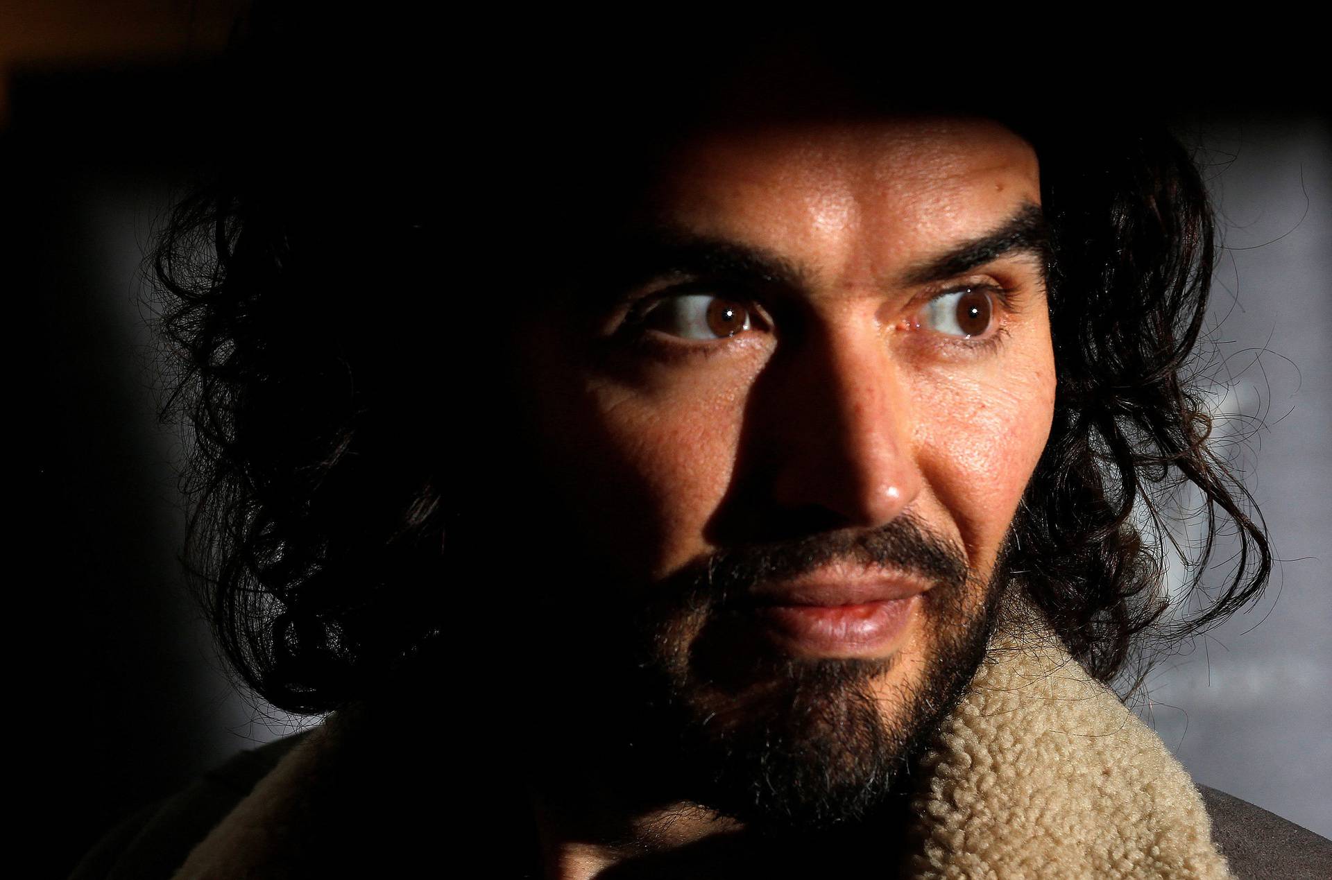 FILE PHOTO: Russell Brand poses for photographers before signing copies of new book entitled "Revolution" in central London