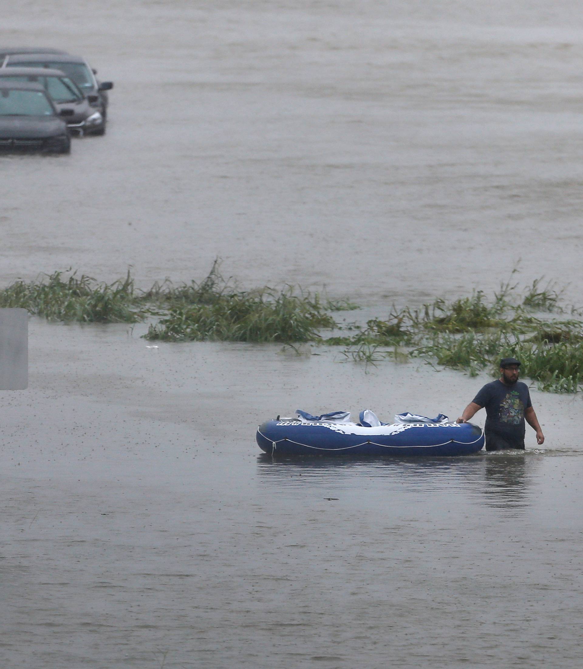 Resident wades through flood waters from Tropical Storm Harvey in east Houston