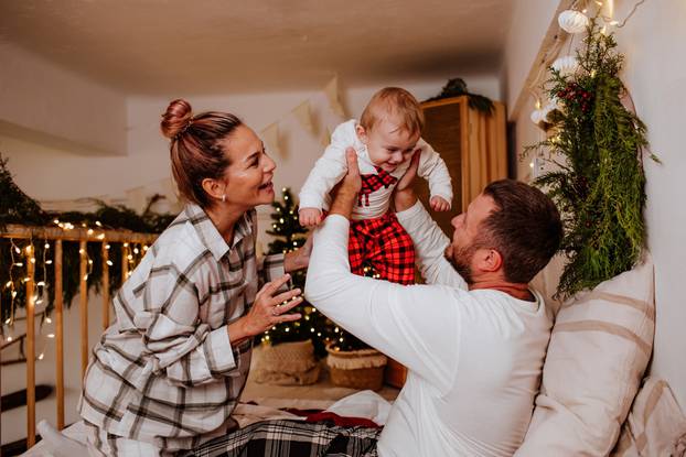 Happy,Family,Of,Three,In,Winter,Pyjamas,Is,Playing,With