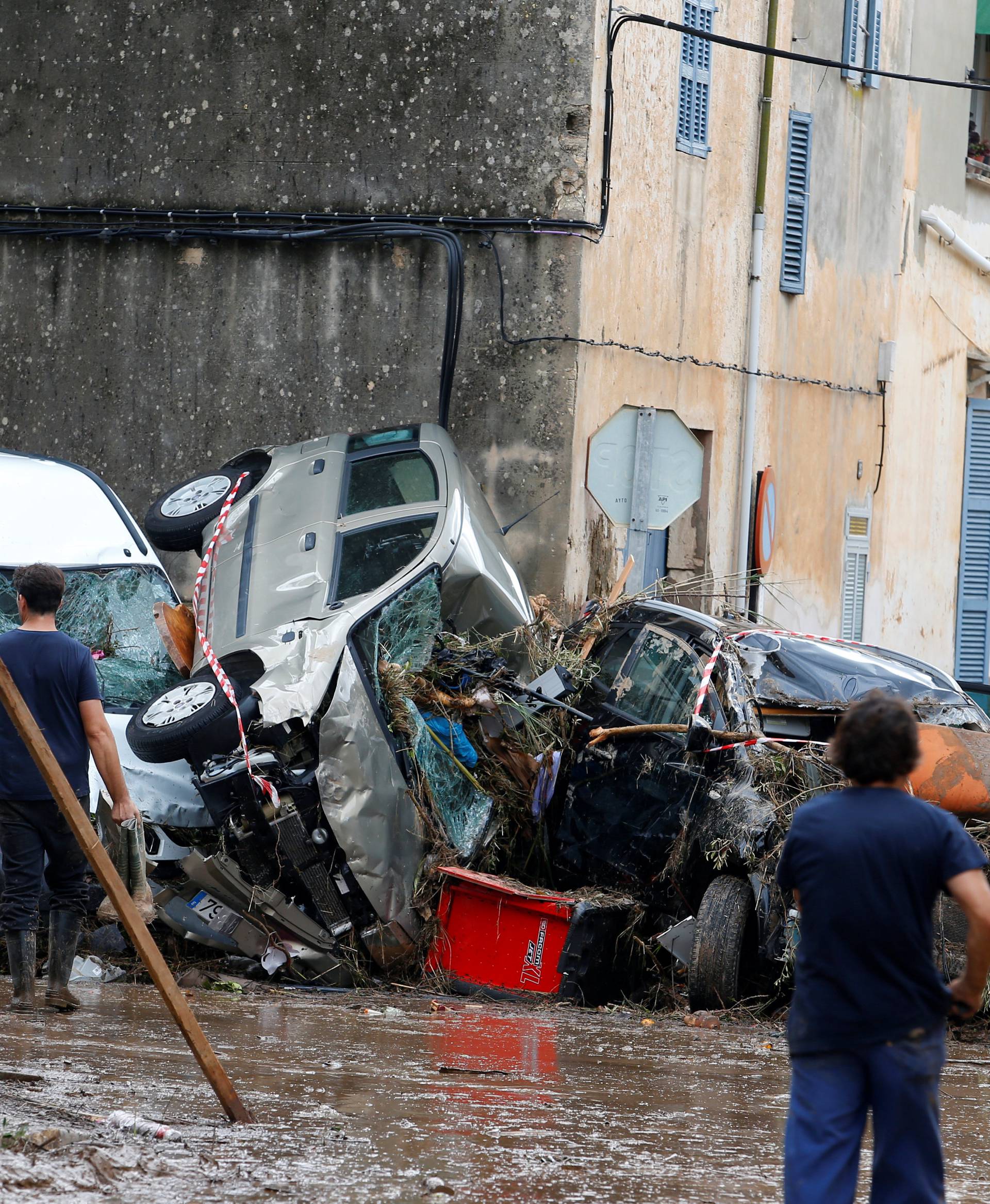 People clear debris as heavy rain and flash floods hit Sant Llorenc de Cardassar on the island of Mallorca