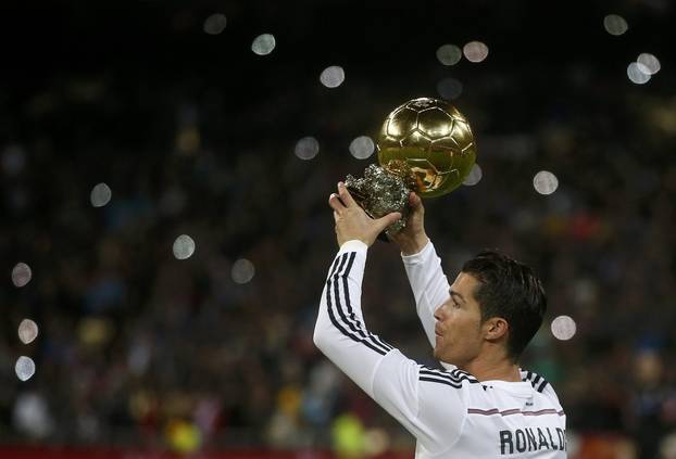 Real Madrid's Cristiano Ronaldo holds up his FIFA Ballon d'Or trophy prior to their King's Cup round of 16 second leg soccer match against Atletico Madrid in  Madrid