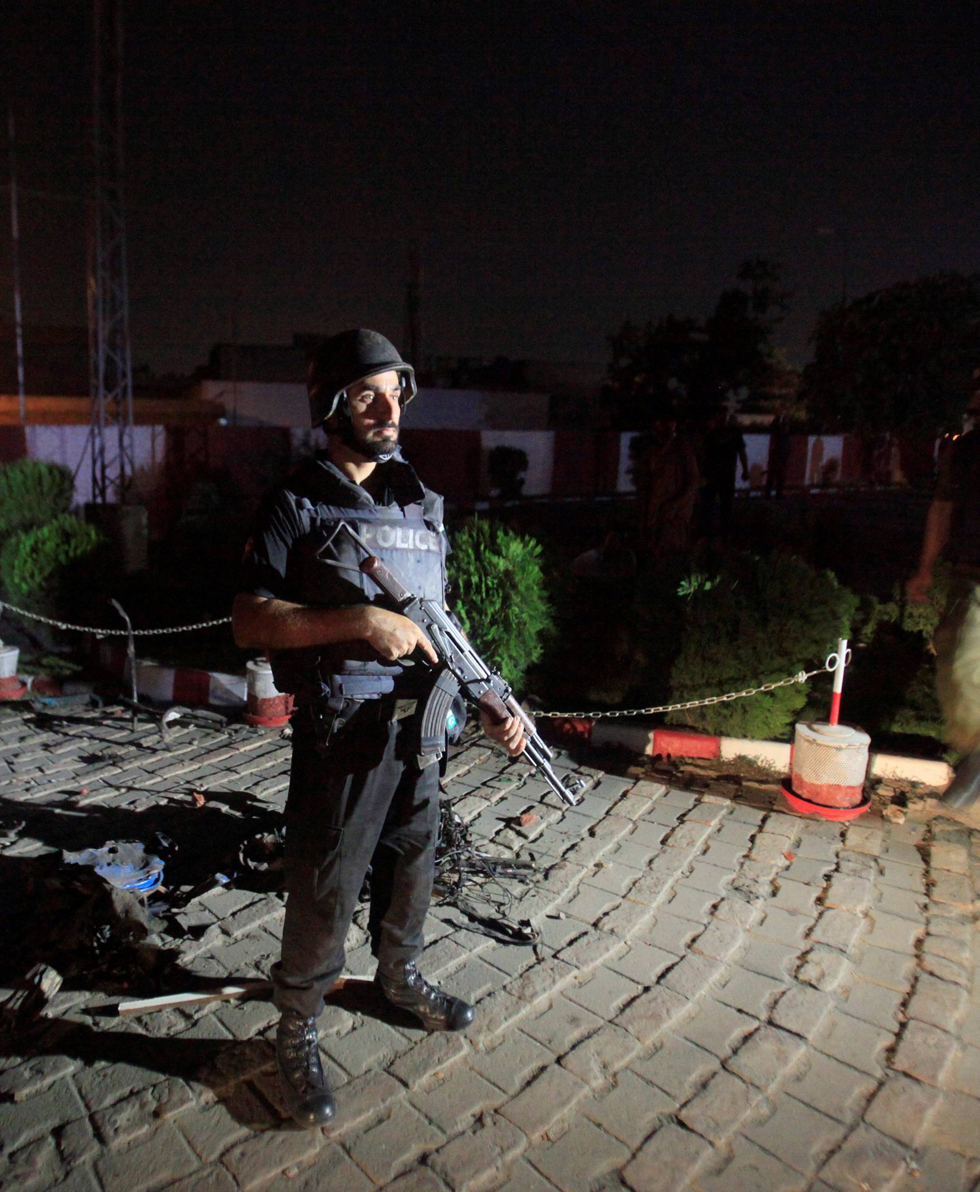 A policeman stands guard after a blast in Lahore