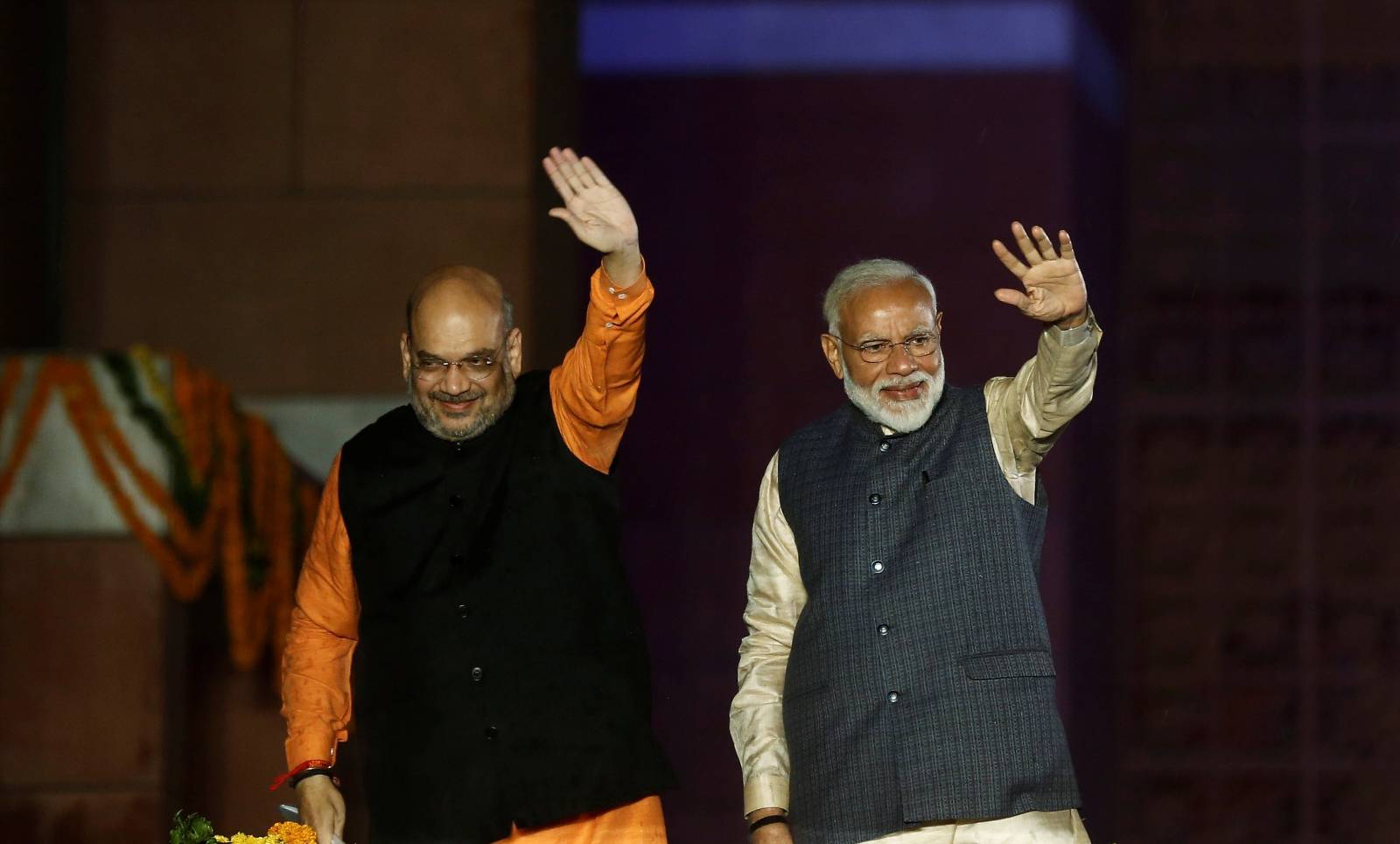Indian Prime Minister Narendra Modi and Bharatiya Janata Party (BJP) President Amit Shah wave towards their supporters after the election results at party headquarter in New Delhi
