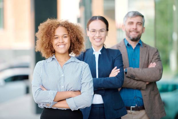 Happy Young Intercultural Leader of Contemporary Business Team in Front of Row