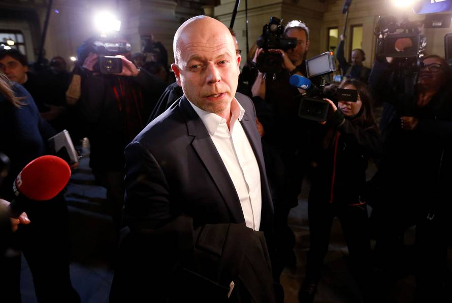 Belgian lawyer Mary, who is defending Salah Abdeslam, is surrounded by reporters as he leaves a courtroom at Brussels Palace of Justice