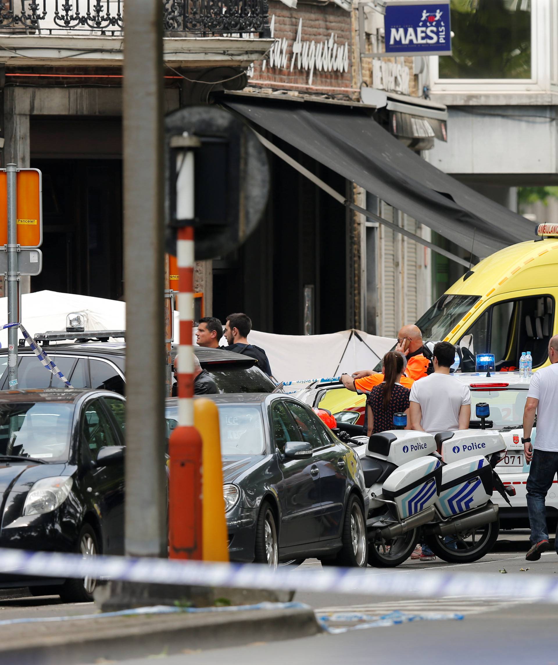 An ambulance car is seen on the scene of a shooting in Liege