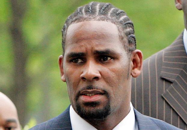 FILE PHOTO: Recording artist R. Kelly arrives at the Cook County Criminal Courthouse for the first day of his trial in Chicago