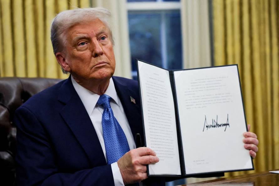 FILE PHOTO: U.S. President Donald Trump signs an executive order in the Oval Office at the White House