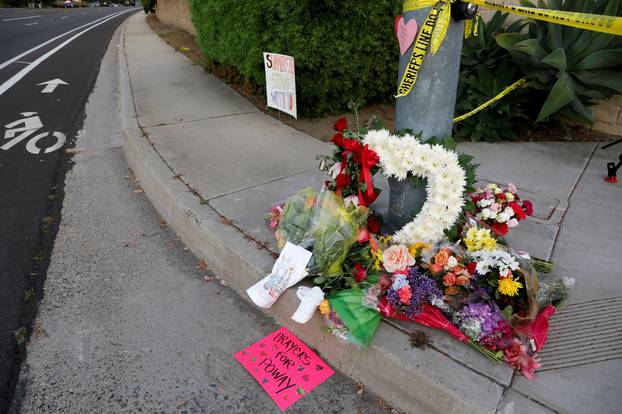 A makeshift memorial is placed by a light pole a block away from a shooting incident where one person was killed at the Congregation Chabad synagogue in Poway