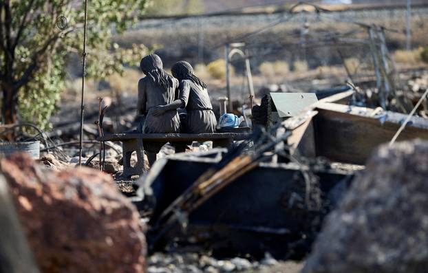 A statue in burned home remains at Hawk Fire in Reno
